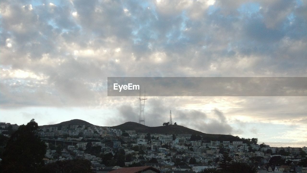 SCENIC VIEW OF MOUNTAINS AGAINST CLOUDY SKY