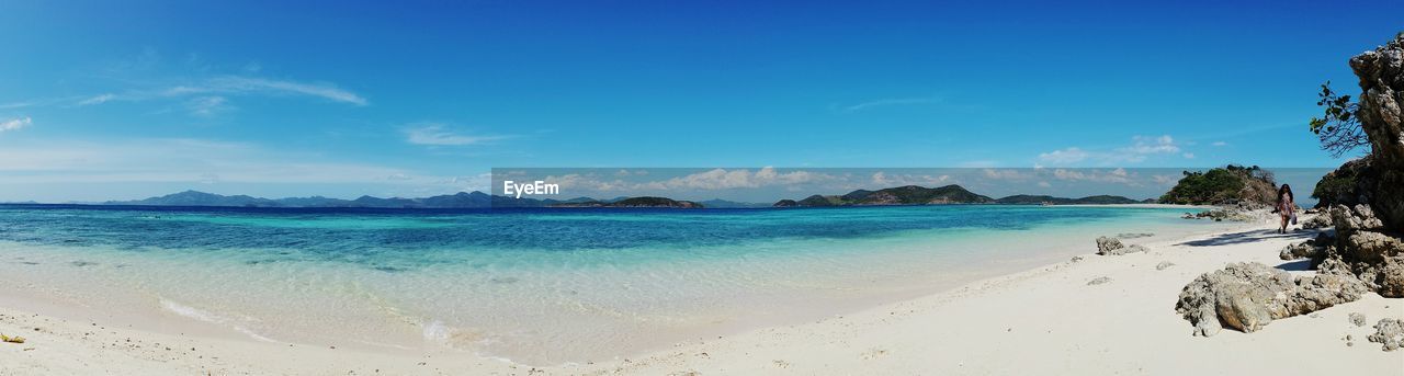 Panoramic view of beach against blue sky