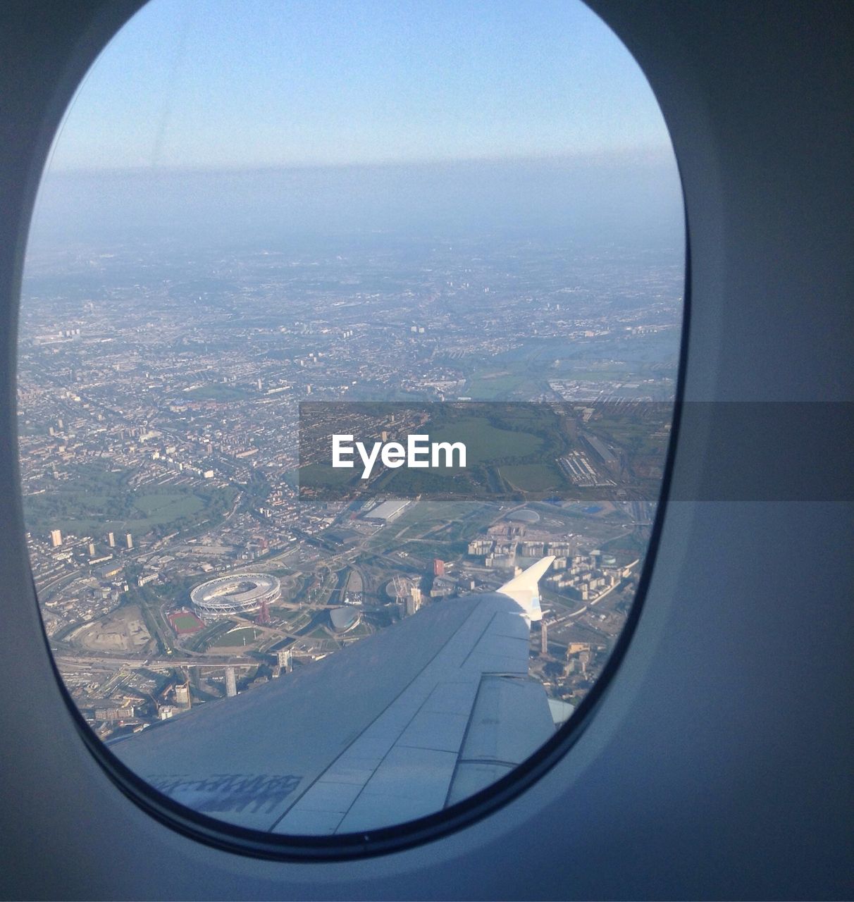 AERIAL VIEW OF LANDSCAPE SEEN THROUGH AIRPLANE WINDOW