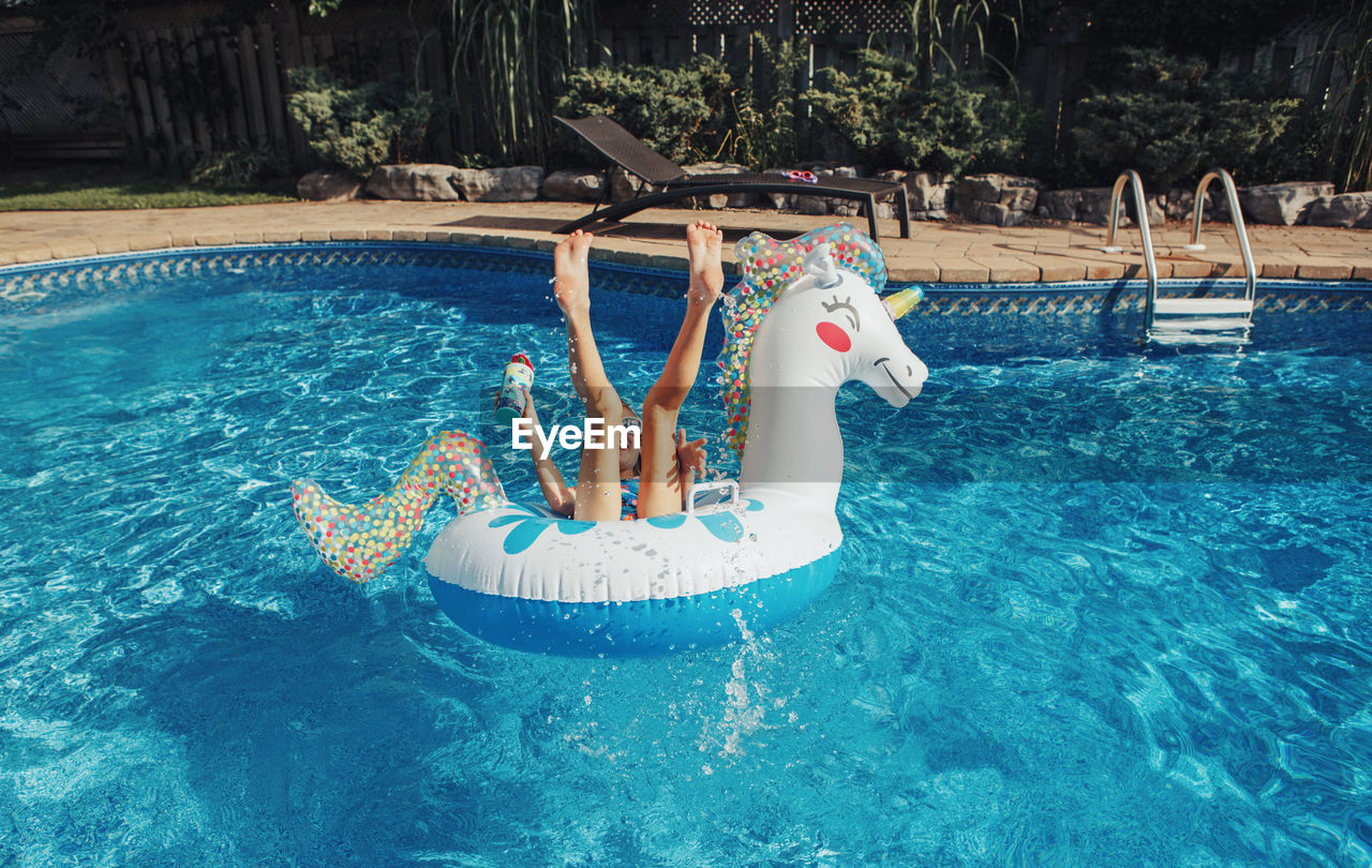 High angle view of girl swimming in pool