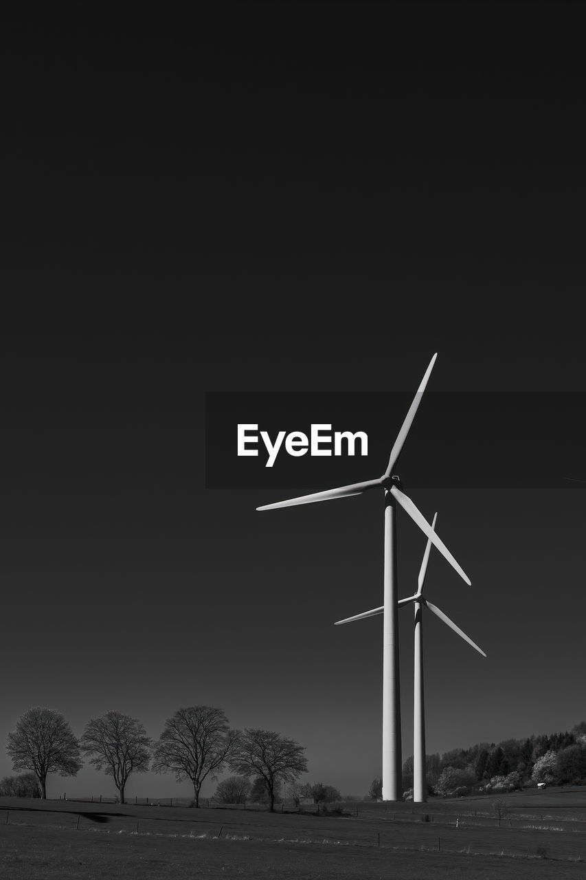 Wind turbines on the field in black and white