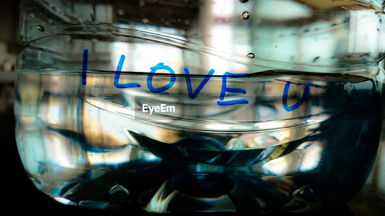 Close-up of i love you text on water bottle