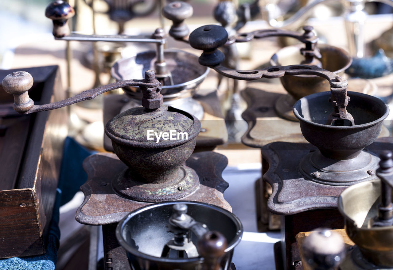 High angle view of antique coffee grinders for sale at market