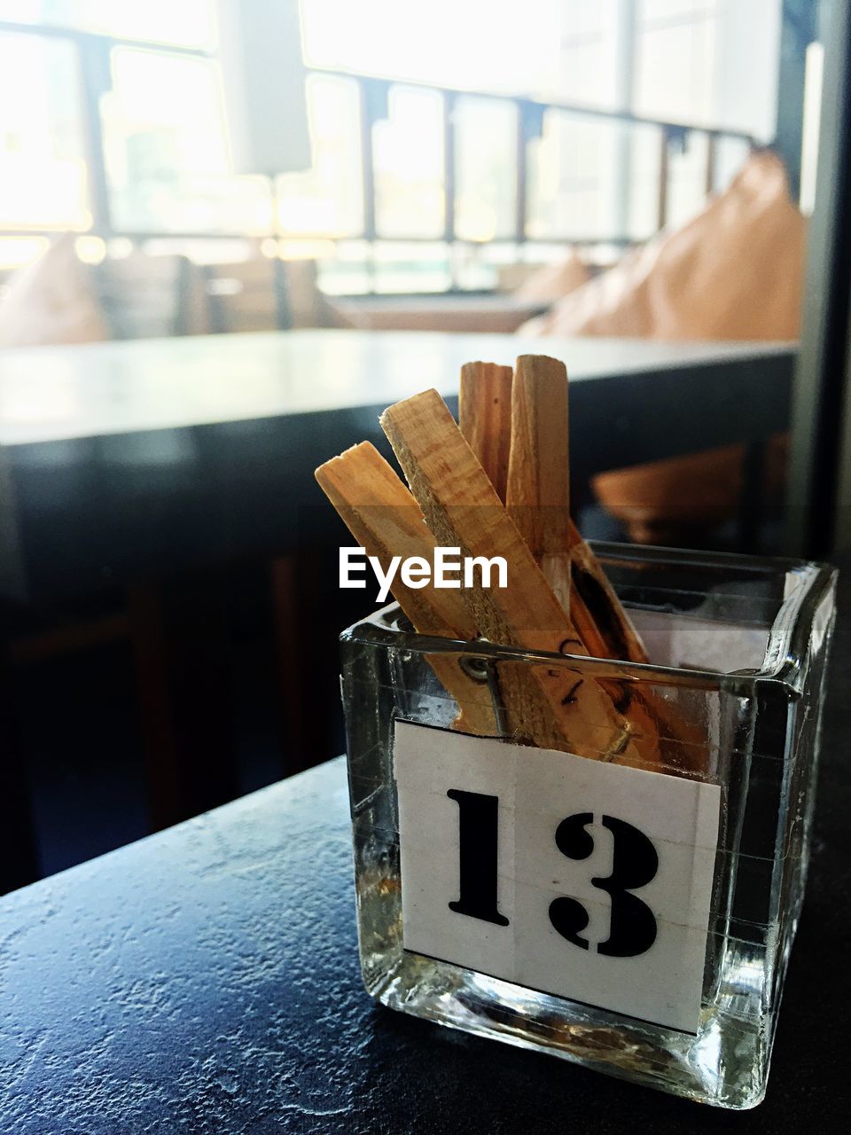 Close-up of wooden clothespin in glass container on table