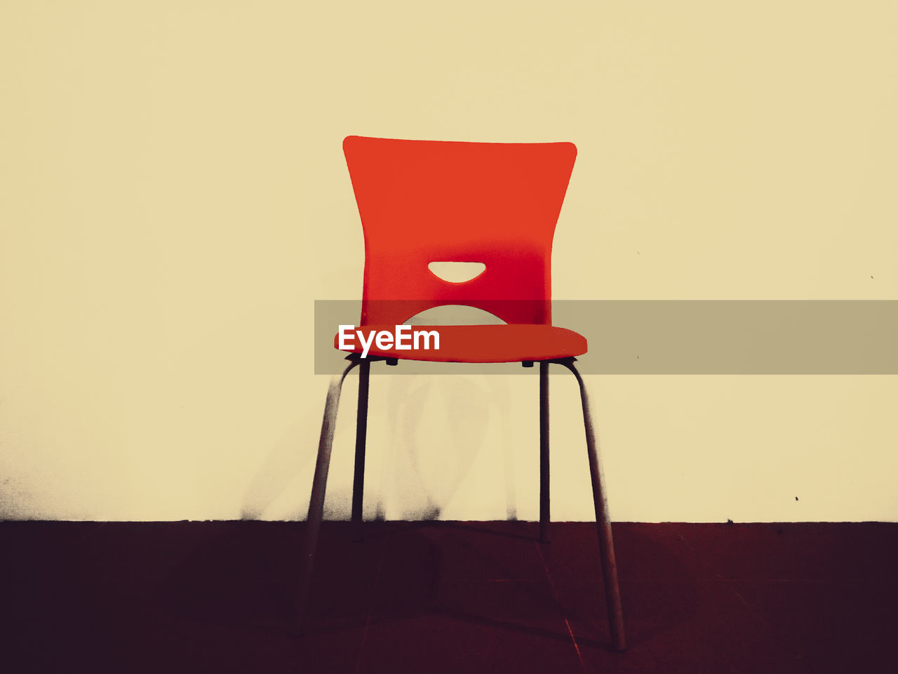 Red chair on table against wall at home