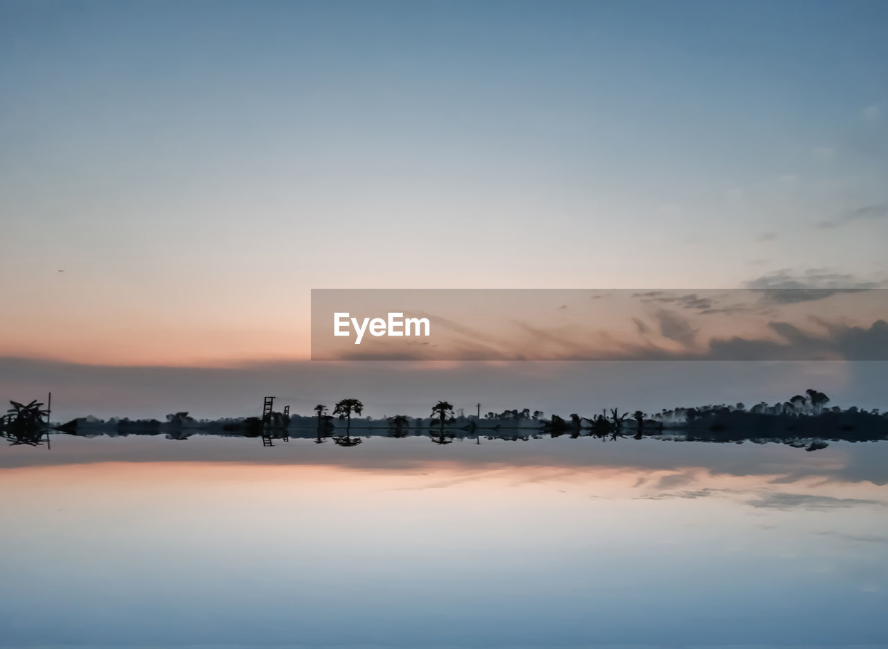 SCENIC VIEW OF LAKE DURING SUNSET