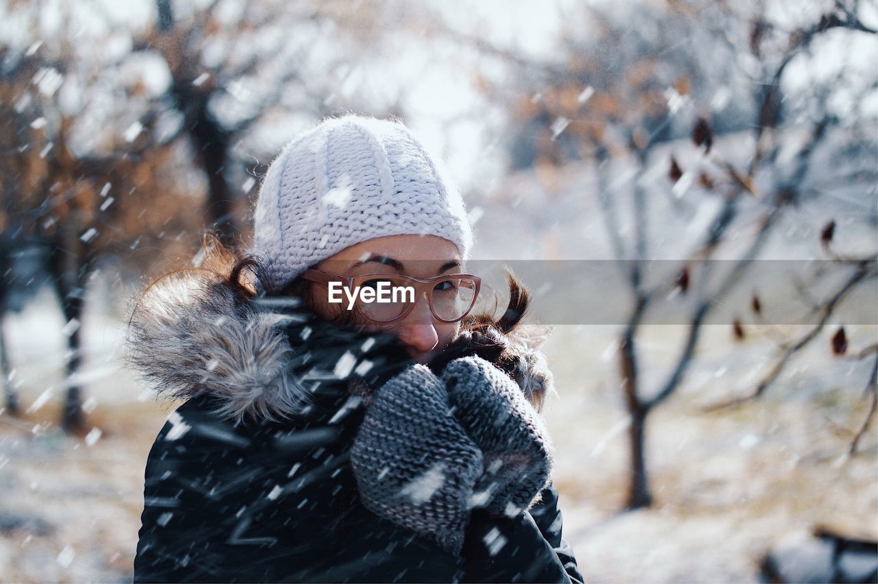 Portrait of mid adult woman during snowfall