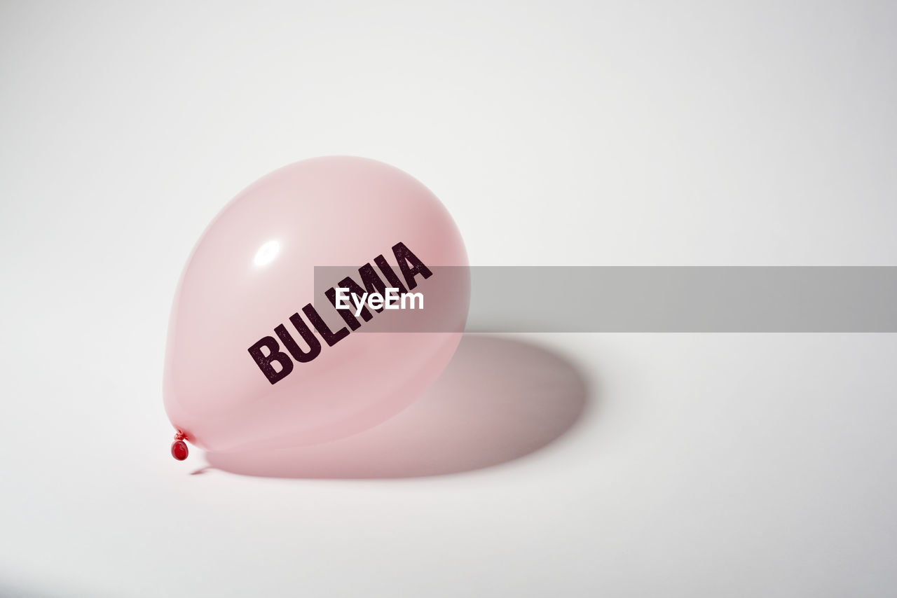 Close-up of balloon with text on white background