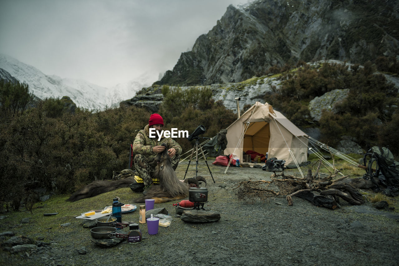 Hunter sitting in front of tent