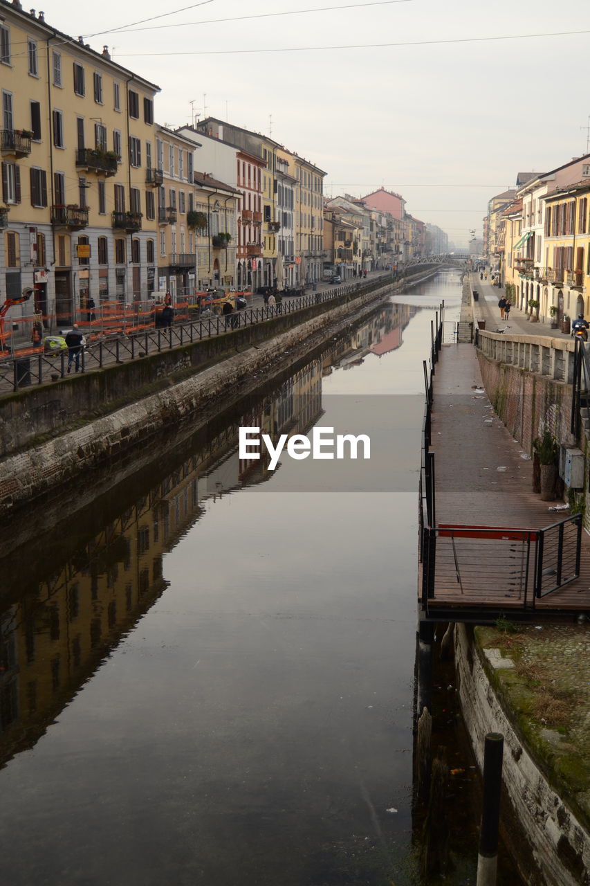 VIEW OF RIVER WITH BUILDINGS IN BACKGROUND