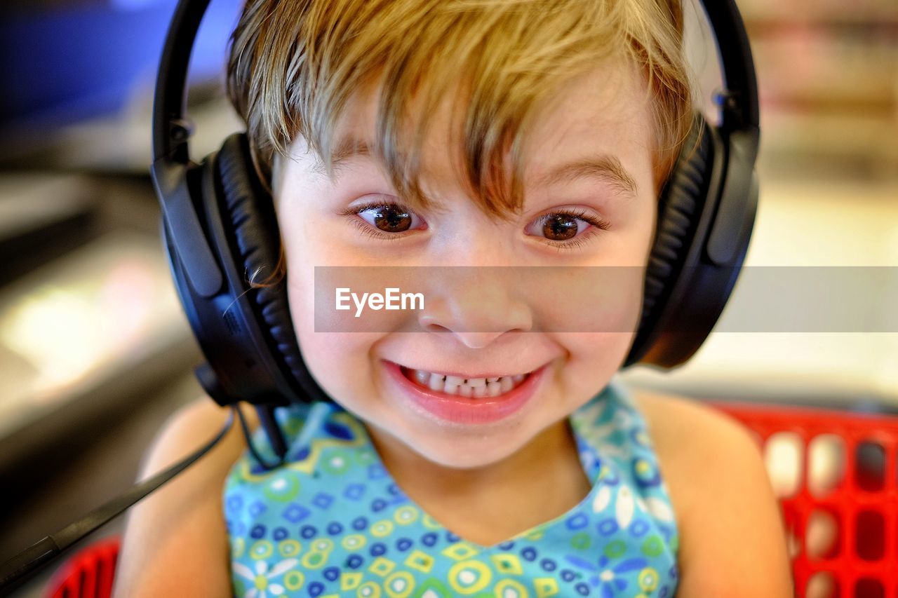 Close-up of girl listening music with headphones