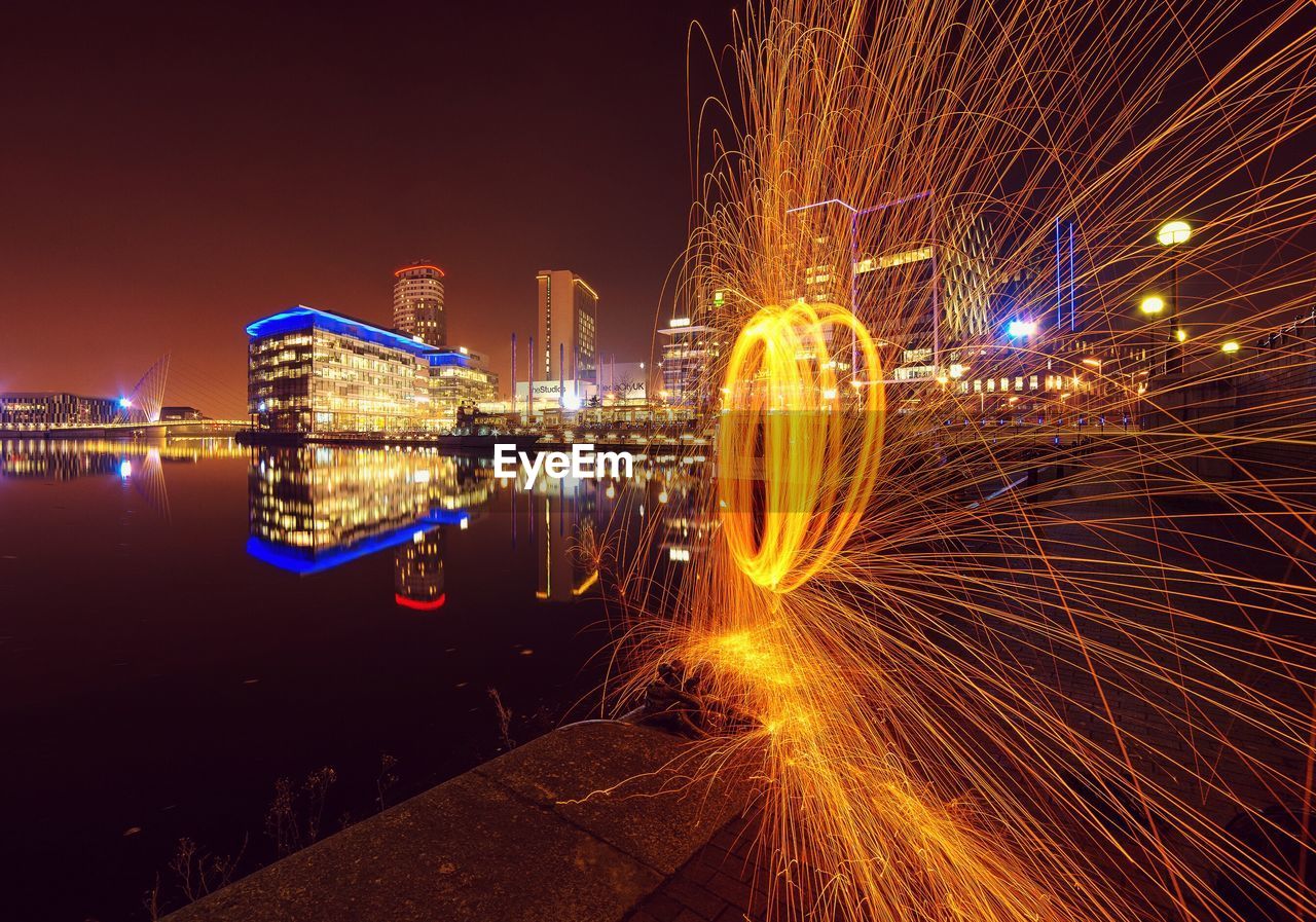 Wire wool and view of cityscape at night
