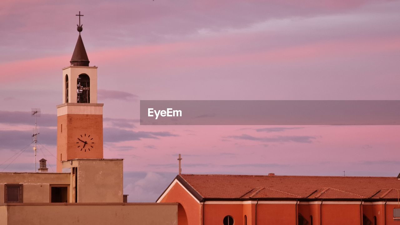 TOWER AMIDST BUILDINGS AGAINST SKY