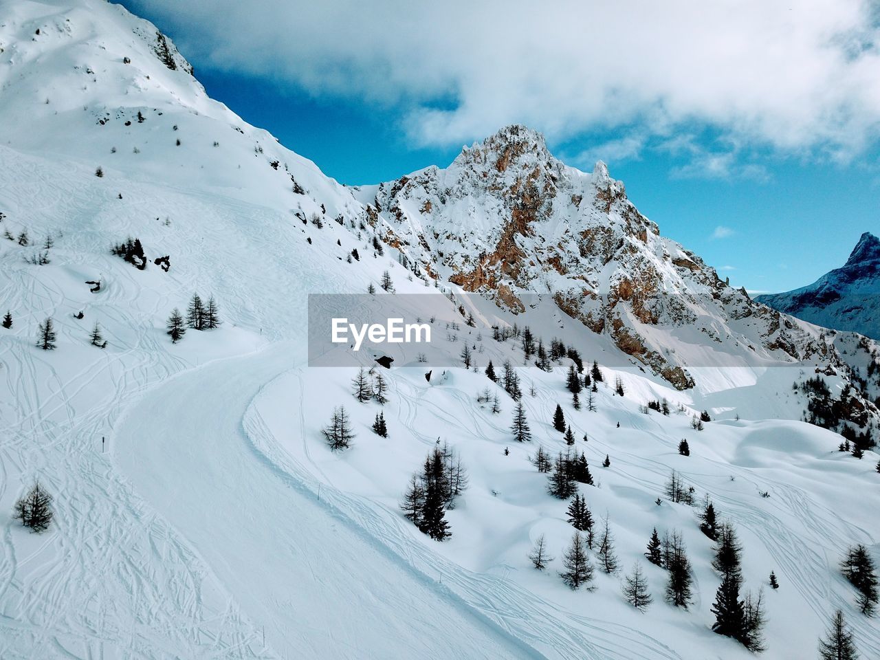 Scenic view of snow covered mountains against sky