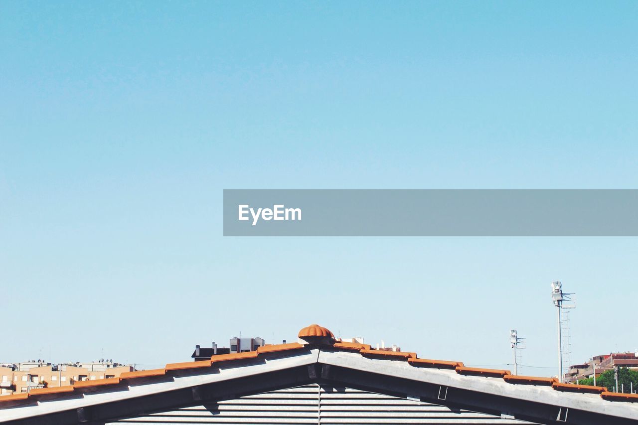 High angle view of house against clear blue sky on sunny day