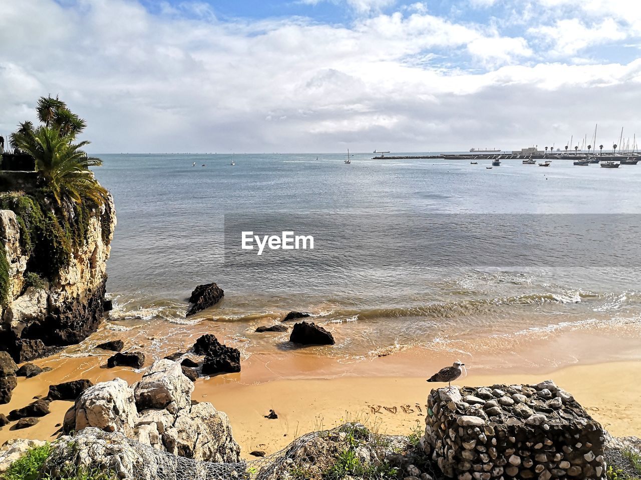 SCENIC VIEW OF ROCKS ON BEACH AGAINST SKY