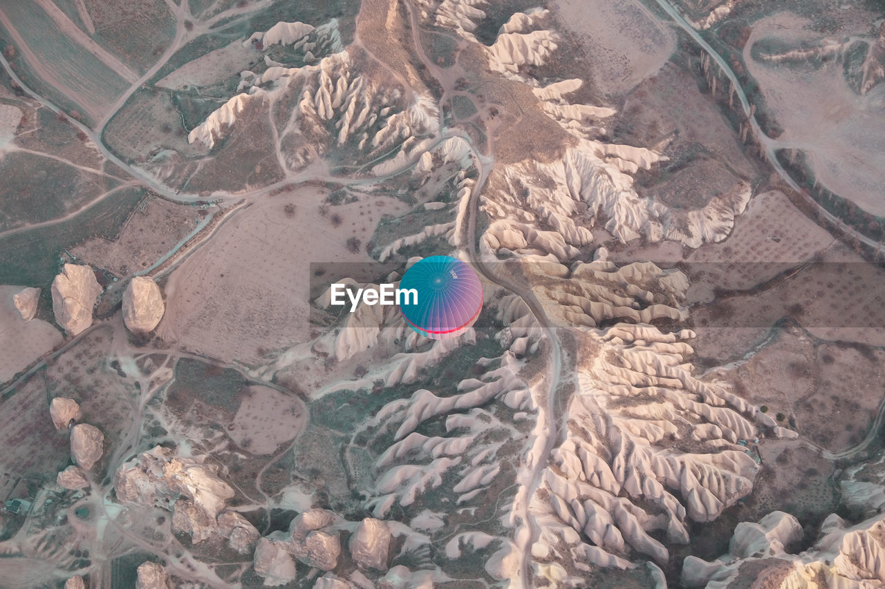 High angle view of ballon over rugged mountains