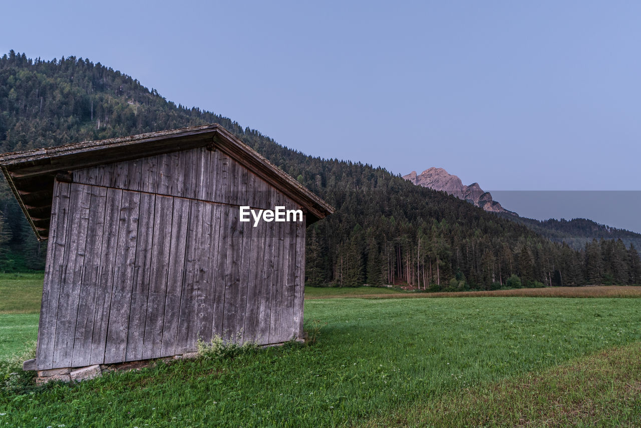 BUILT STRUCTURE ON FIELD AGAINST SKY