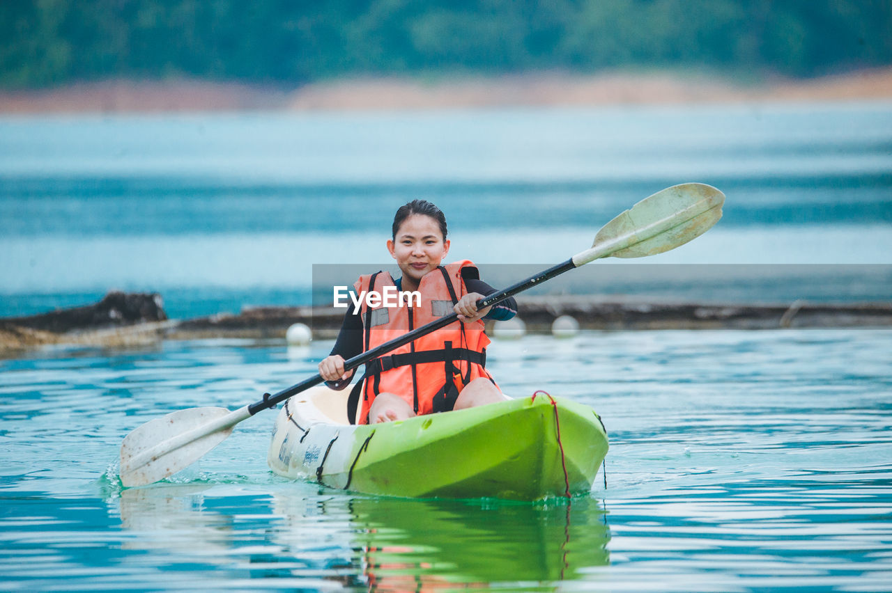 PORTRAIT OF SMILING MAN IN BOAT