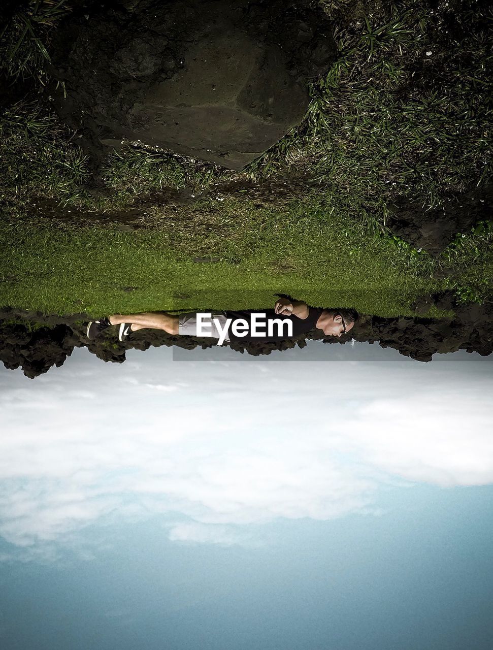 VIEW OF A LAKE WITH REFLECTION OF CLOUDS