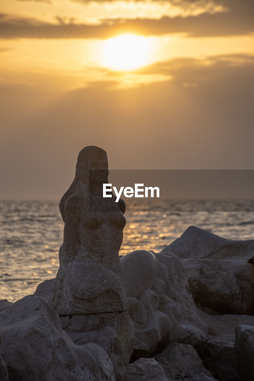 SCENIC VIEW OF BEACH DURING SUNSET