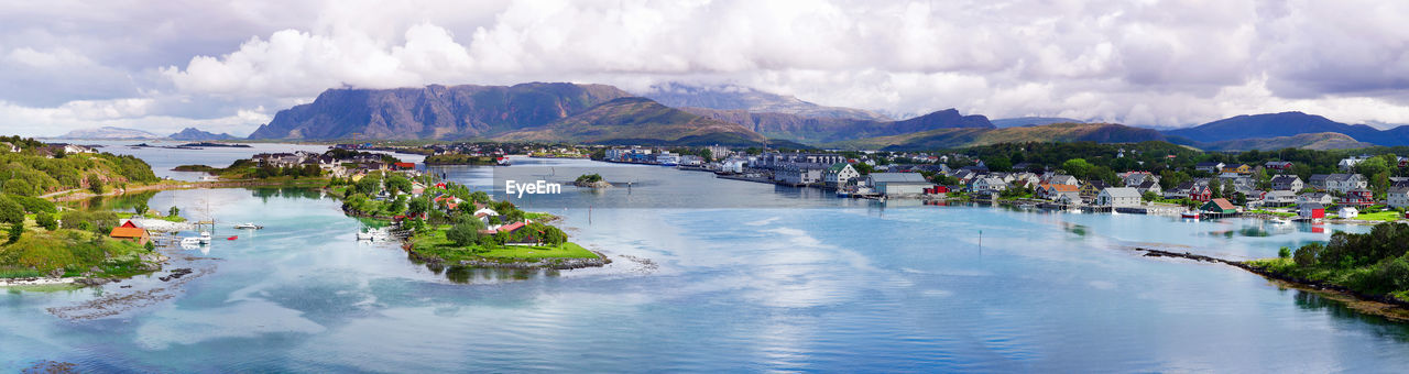 Panoramic view of sea and bronnoysund against cloudy sky