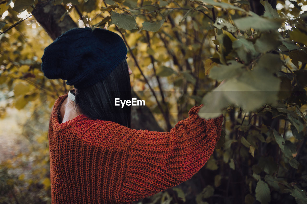 Woman walking through the forest during the day