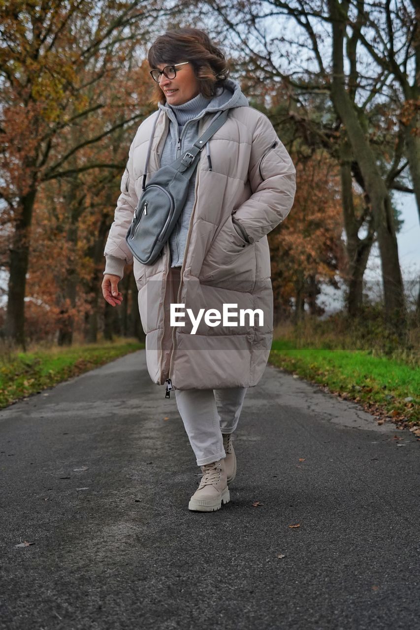 Portrait of young man walking on road