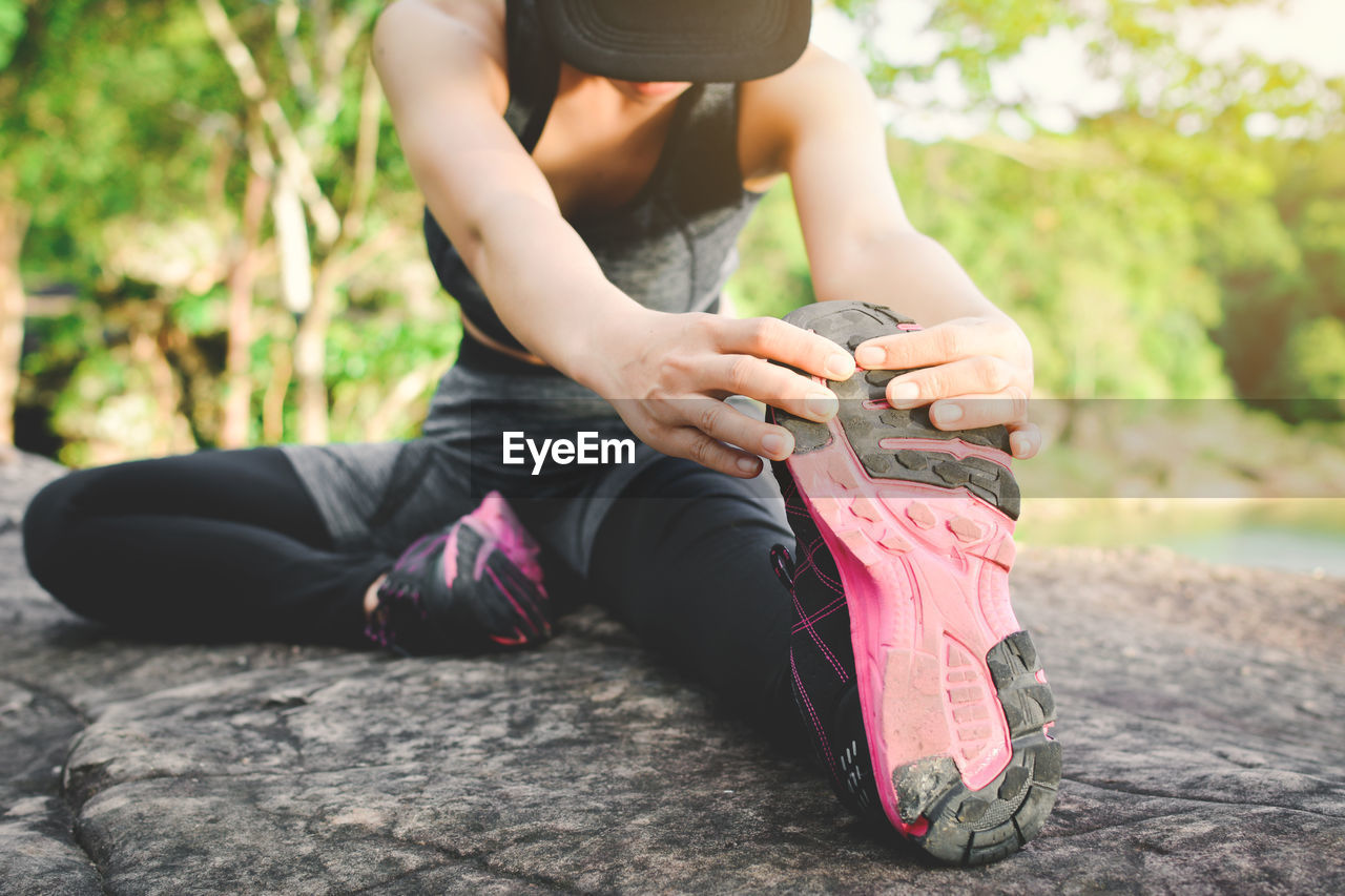 Low section of woman stretching