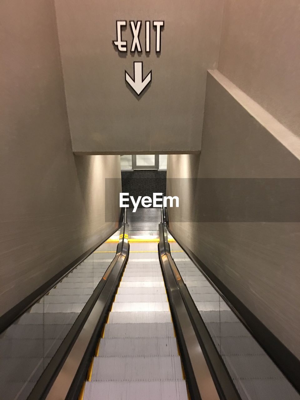 Exit sign over escalator