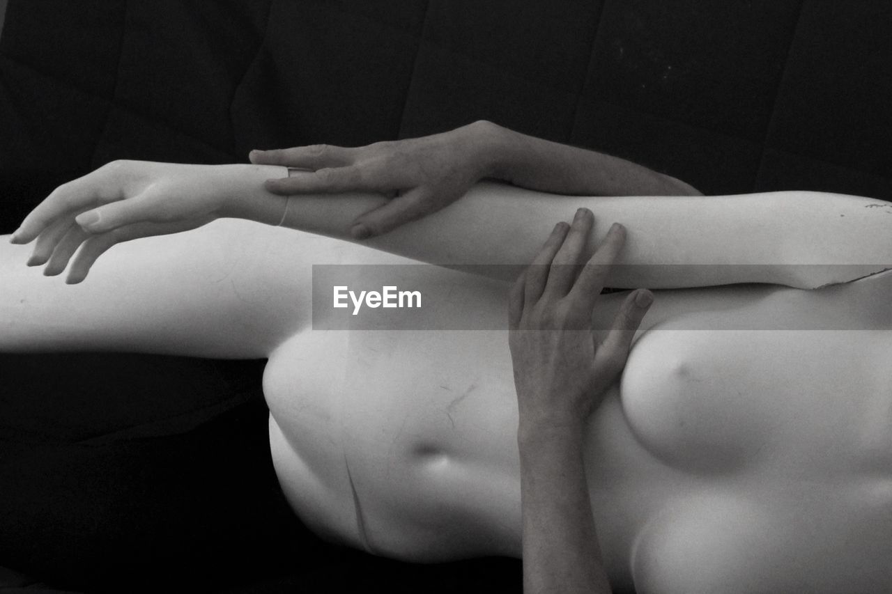 High angle view of person touching mannequin