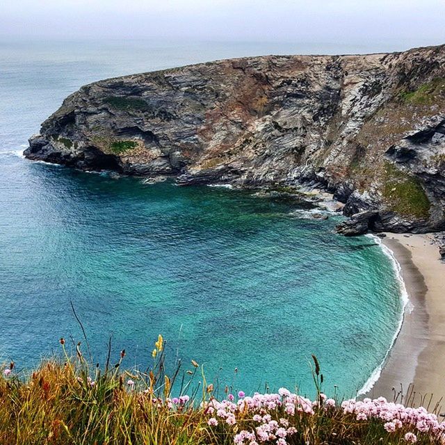 SCENIC VIEW OF SEA WITH ROCKS IN BACKGROUND