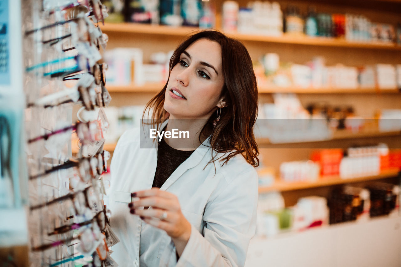 Female optometrist working at store