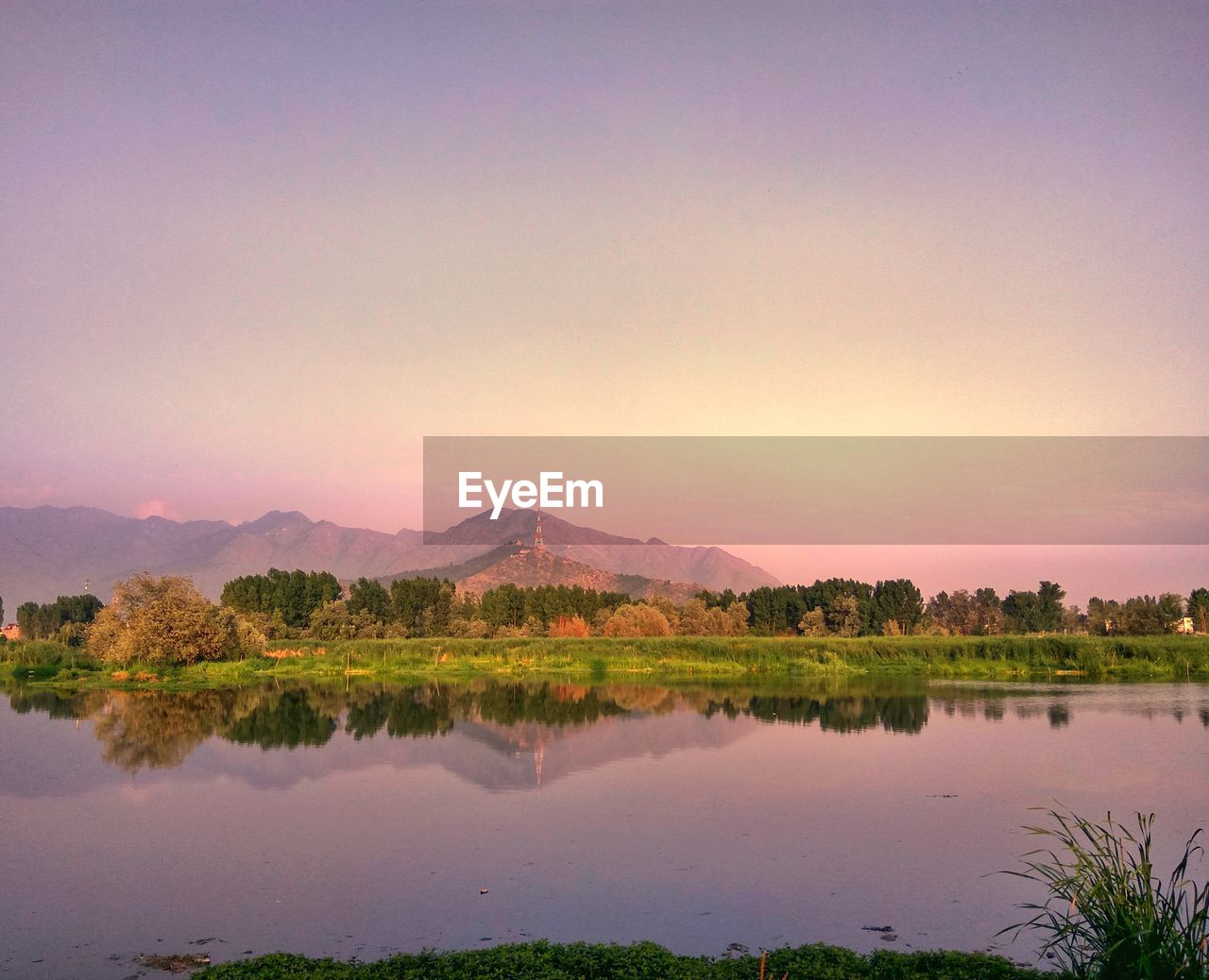 Scenic view of lake against sky during sunset