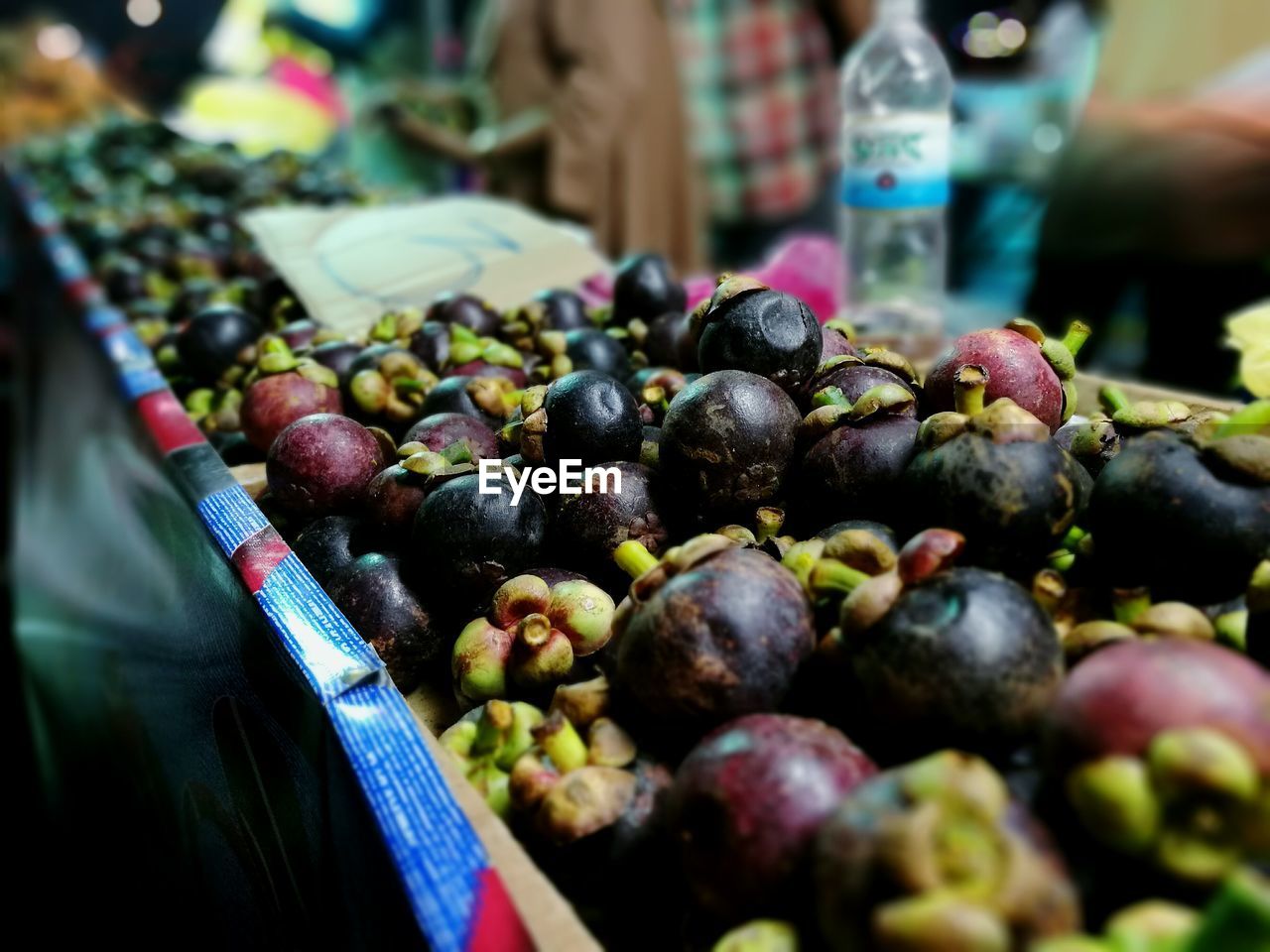 Close-up of mangosteen for sale at market stall