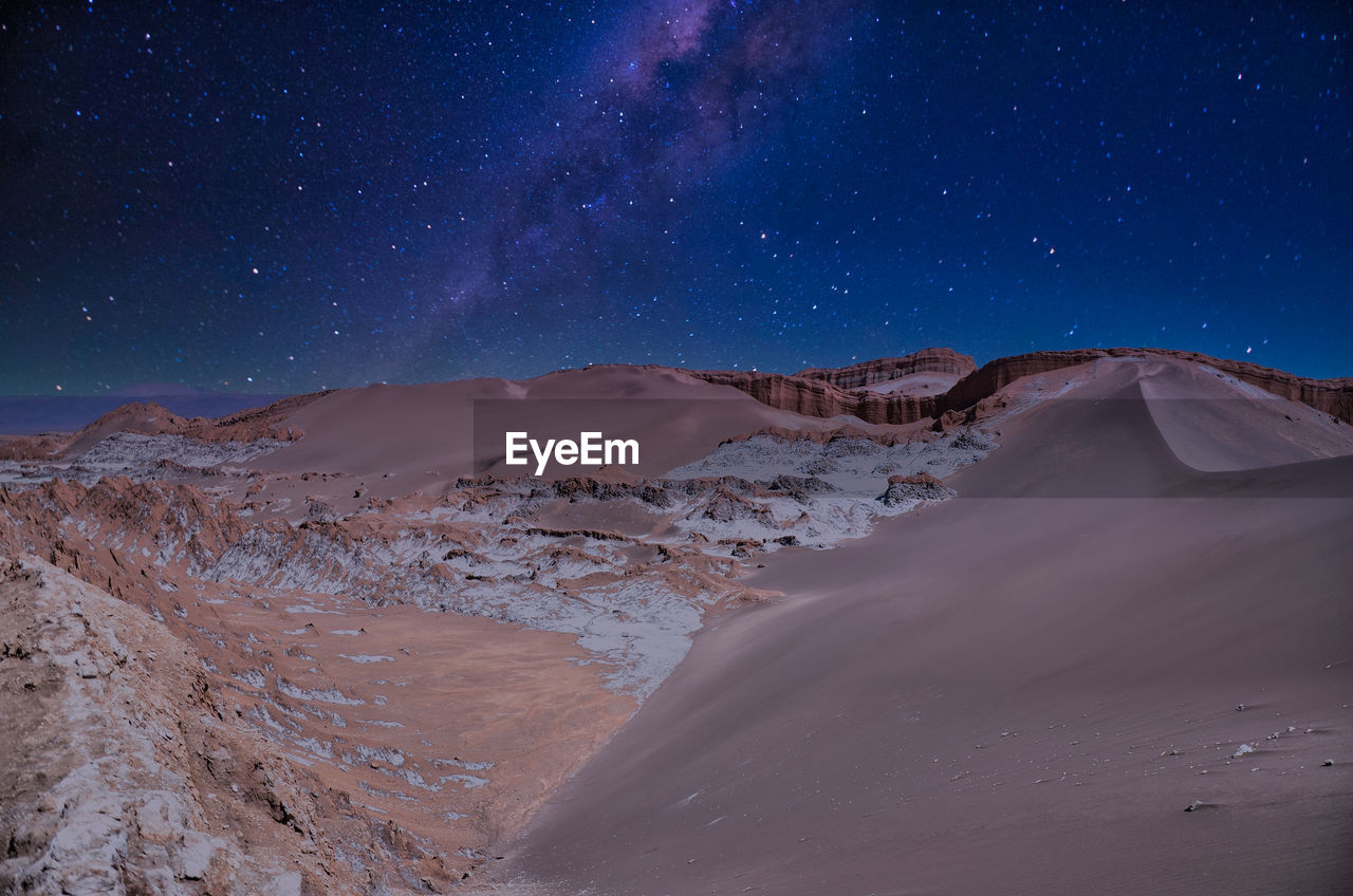 Scenic view of desert against sky at night