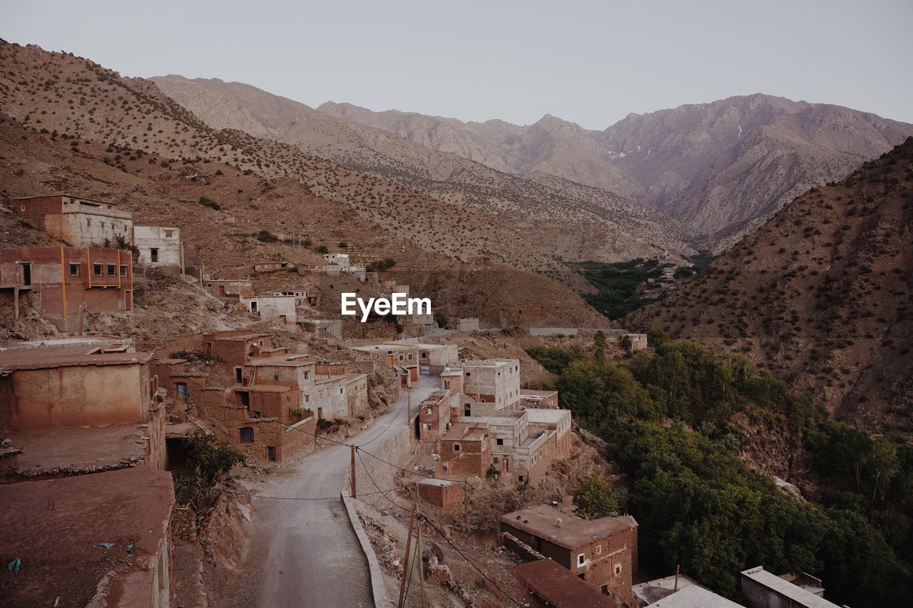 high angle view of townscape and mountains against sky