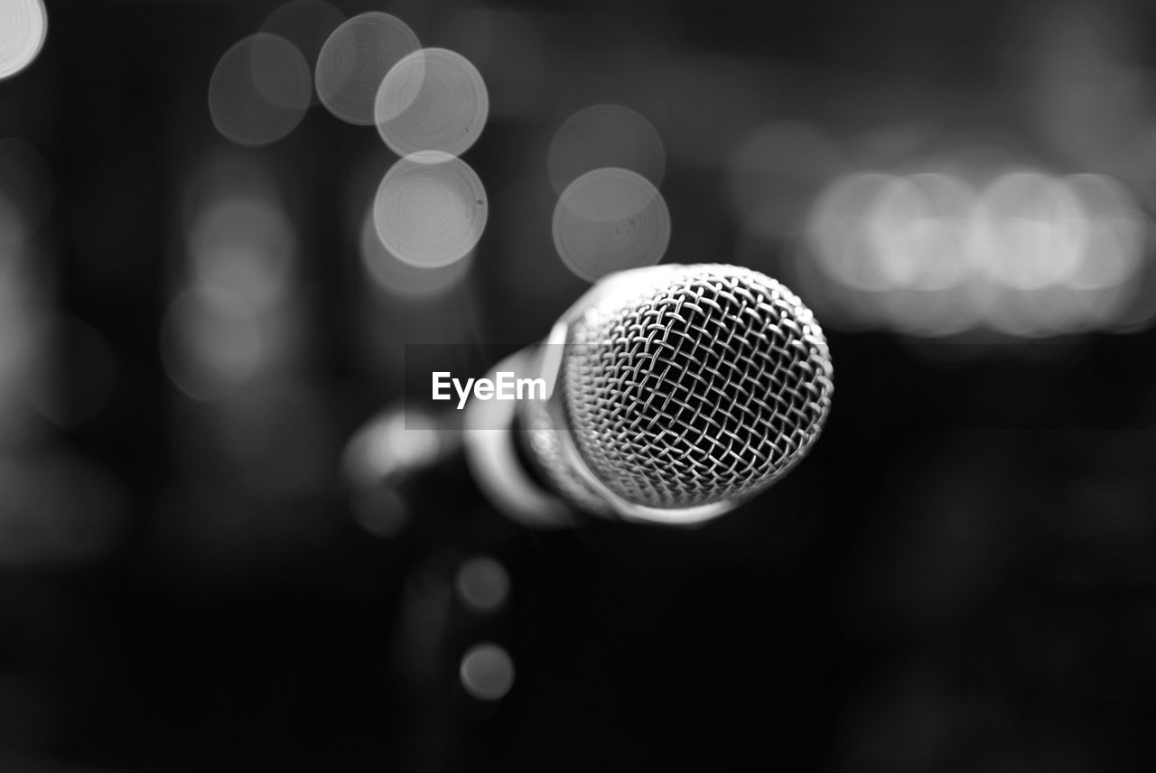 Black and white microphone close-up with background bokeh