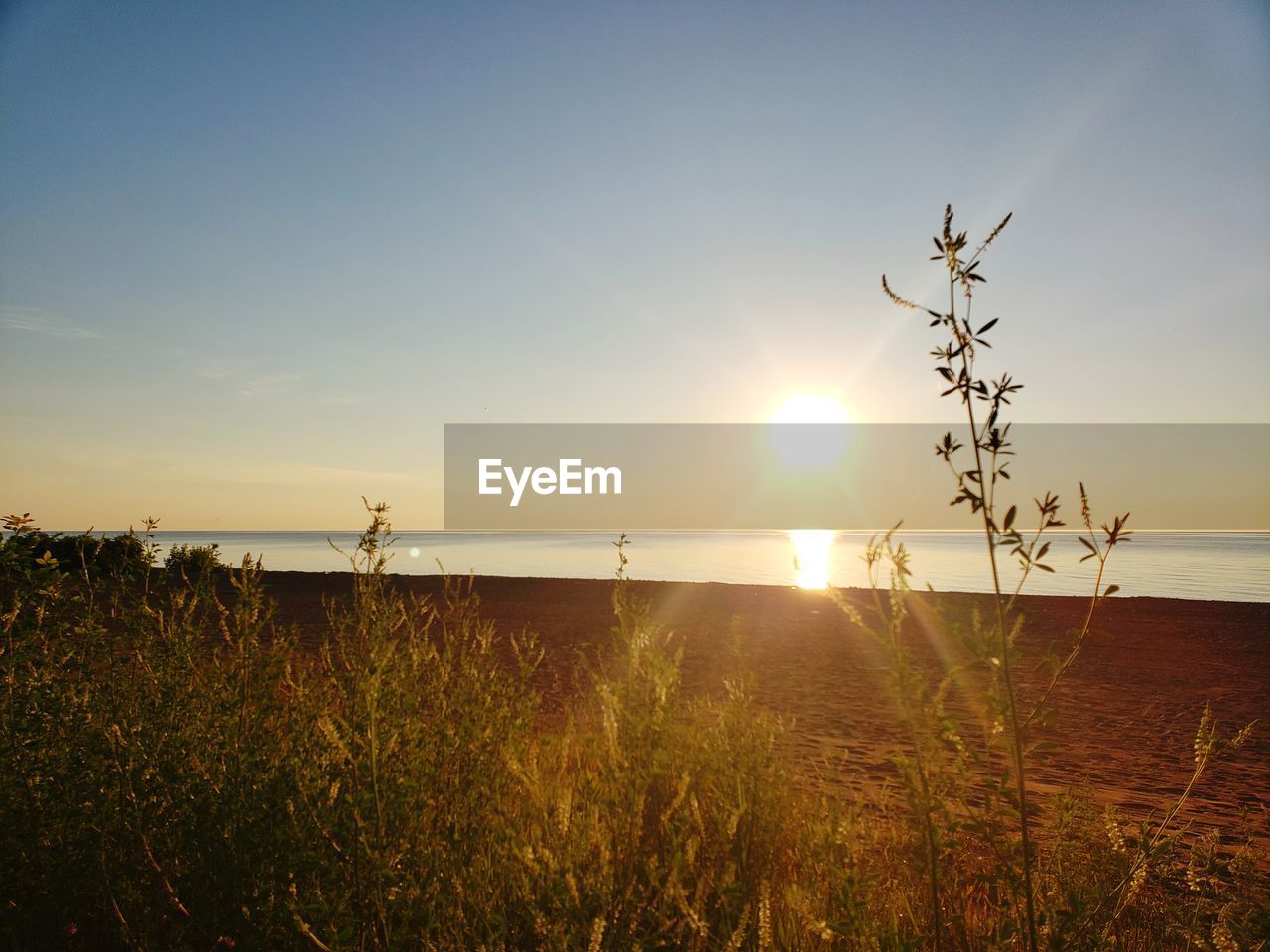 SCENIC VIEW OF SUNSET OVER SEA