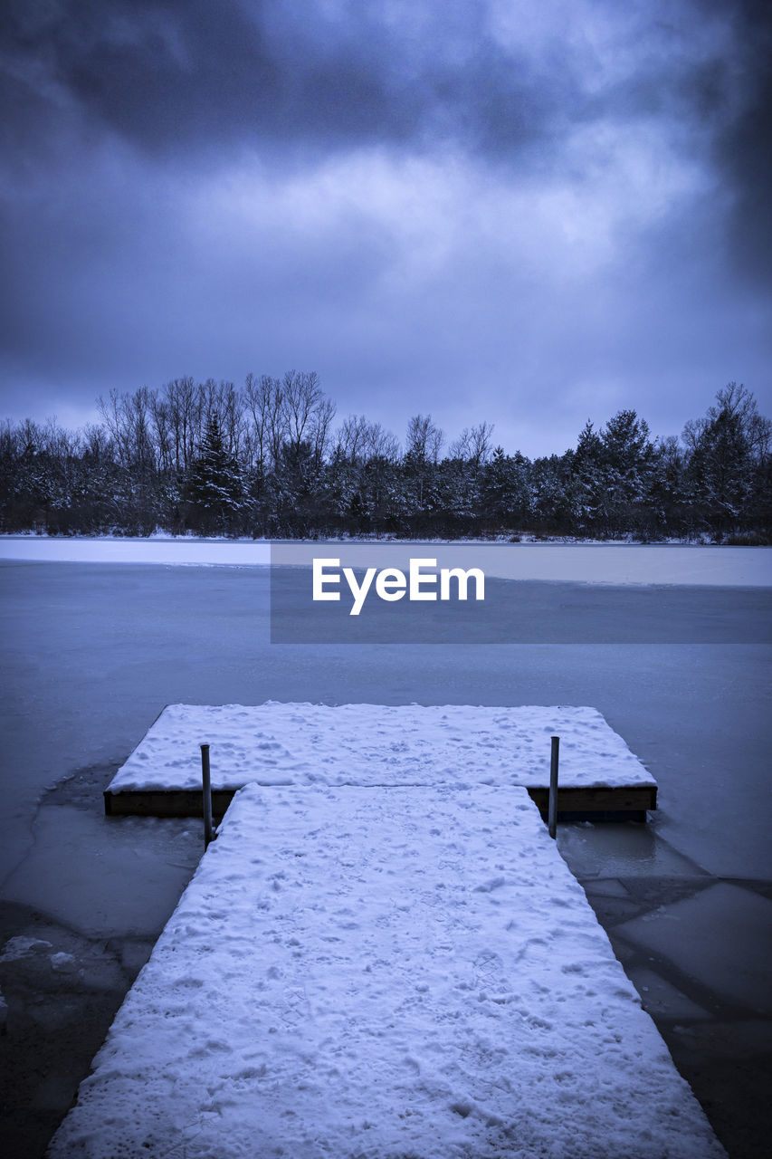 PIER ON LAKE DURING WINTER