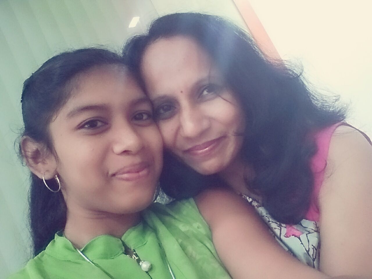 CLOSE-UP PORTRAIT OF HAPPY MOTHER AND DAUGHTER IN BABY