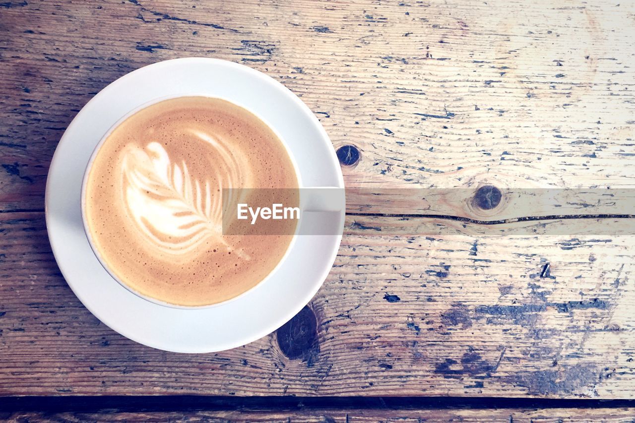 Directly above shot of coffee on wooden table