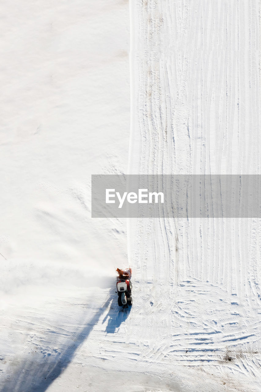 HIGH ANGLE VIEW OF PERSON ON SNOW