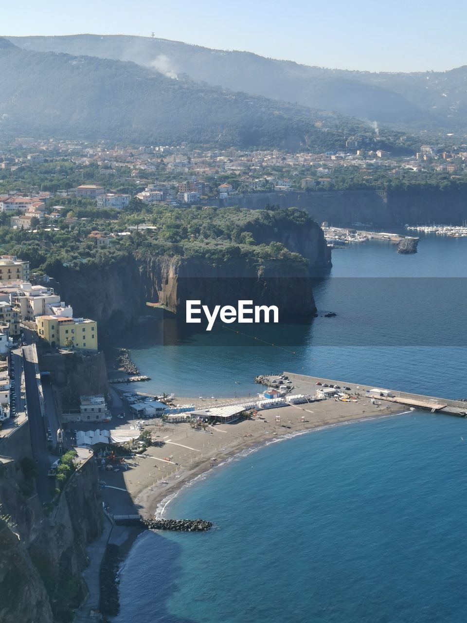 HIGH ANGLE SHOT OF TOWNSCAPE BY SEA