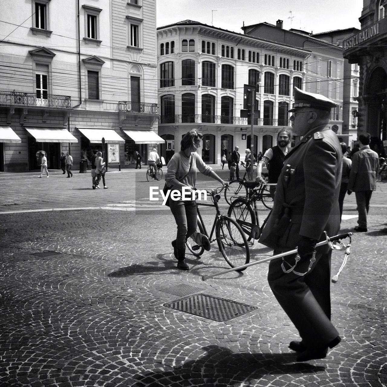 MAN STANDING ON FOOTPATH IN CITY