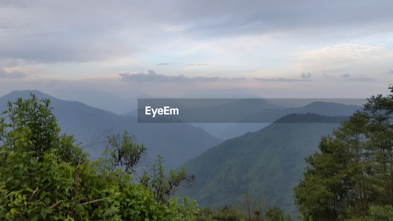 SCENIC VIEW OF LANDSCAPE AND MOUNTAINS AGAINST SKY