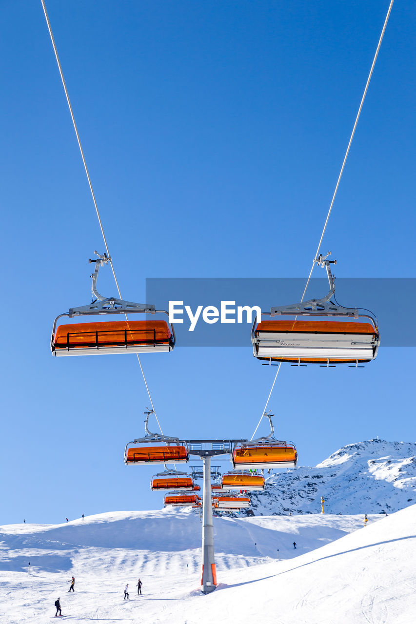 LOW ANGLE VIEW OF SKI LIFT IN SNOW