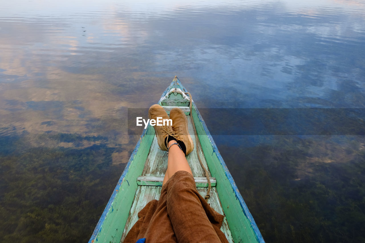 Low section of person in boat on lake