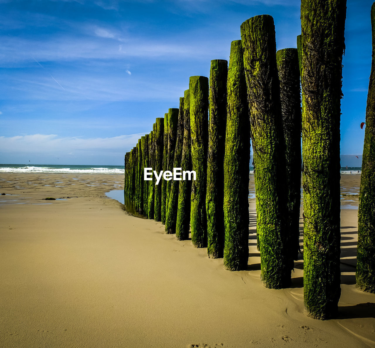 Scenic view of beach against blue sky