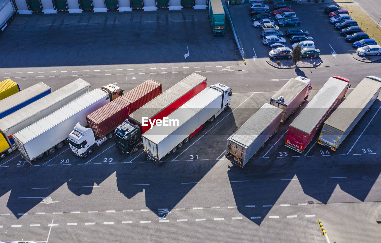 Trucks unloading in logostics center. aerial view